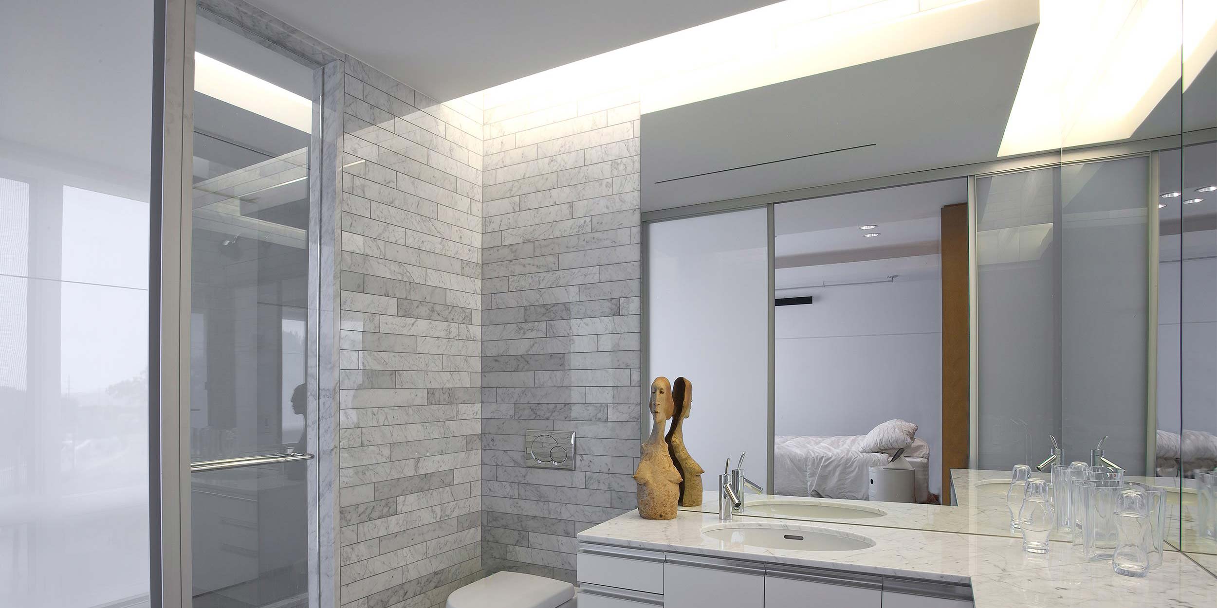 wooden spa-like bathroom with large stone fixtures